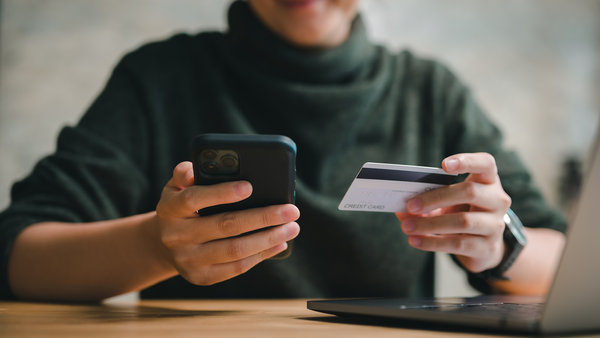 woman hand using smartphone and holding credit card for shopping payment online