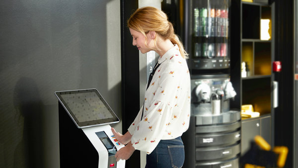 Woman paying self-service check out
